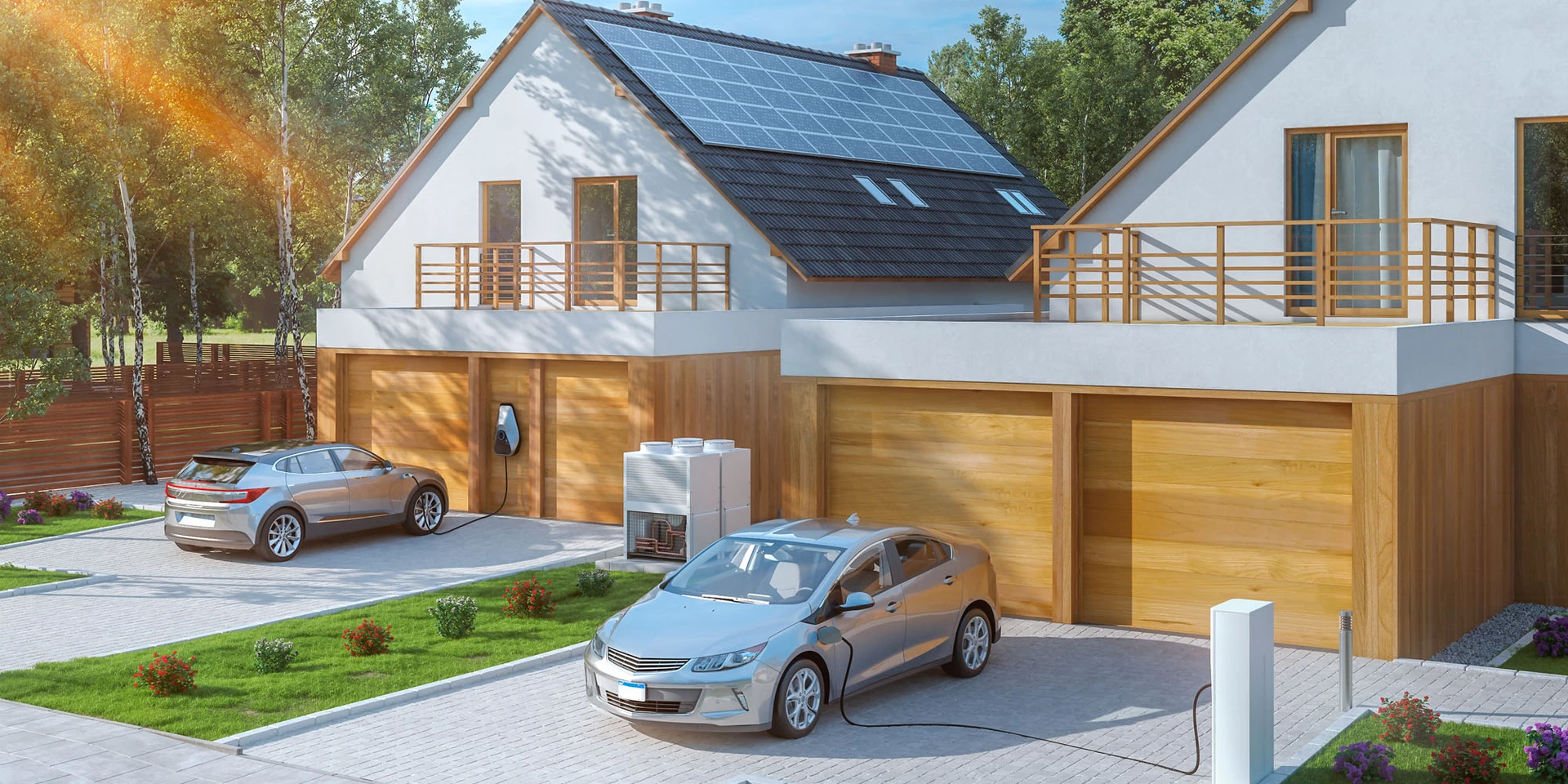 Zwei Eigentum-Häuser, mit jeweils eine Photovoltaikanlage und Wallbox. An der Wallbox stehen E-Autos zum Laden.